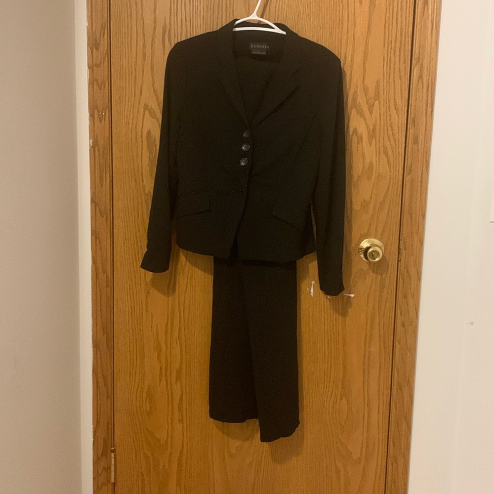 Pinstriped black pant suit ruching details on the hands and front.